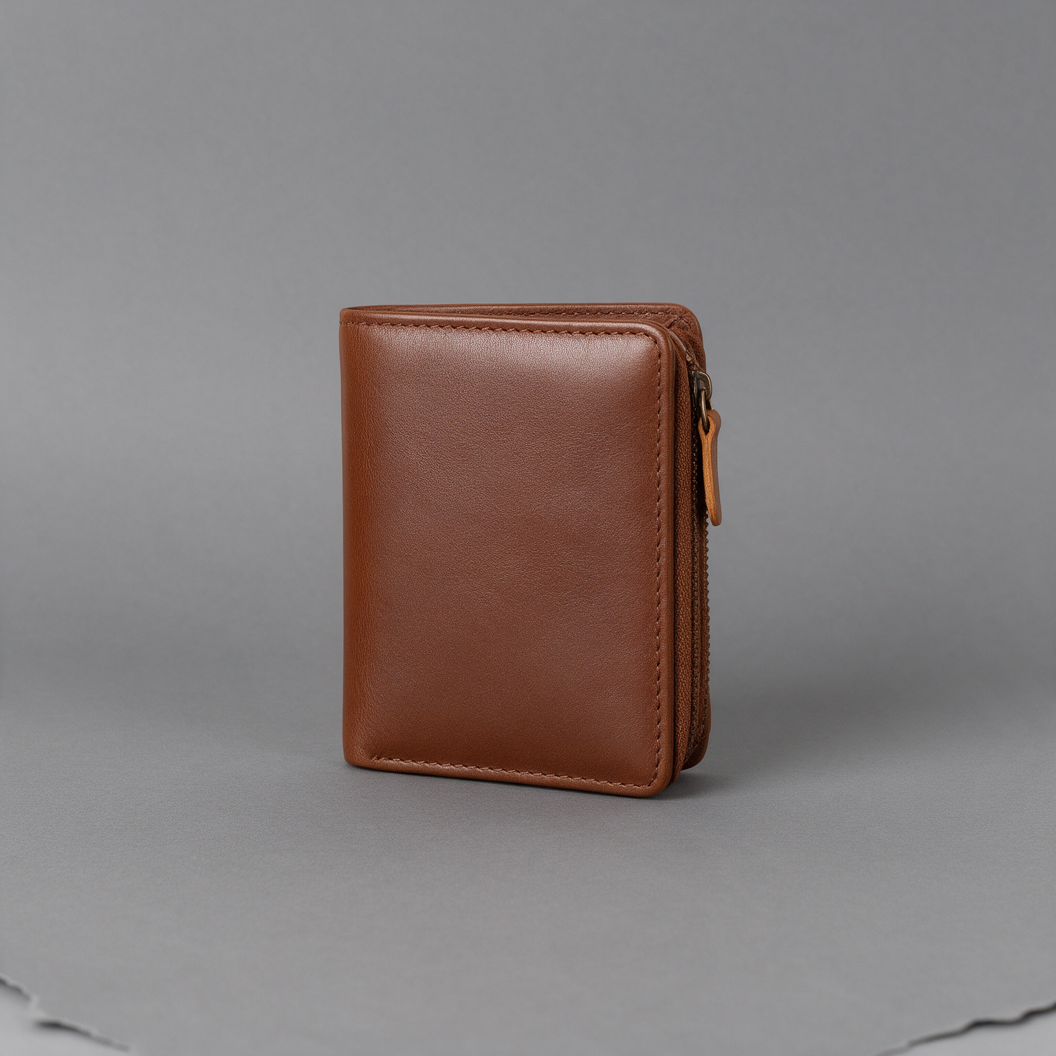 Leather wallet photographed on a grey studio backdrop before editing