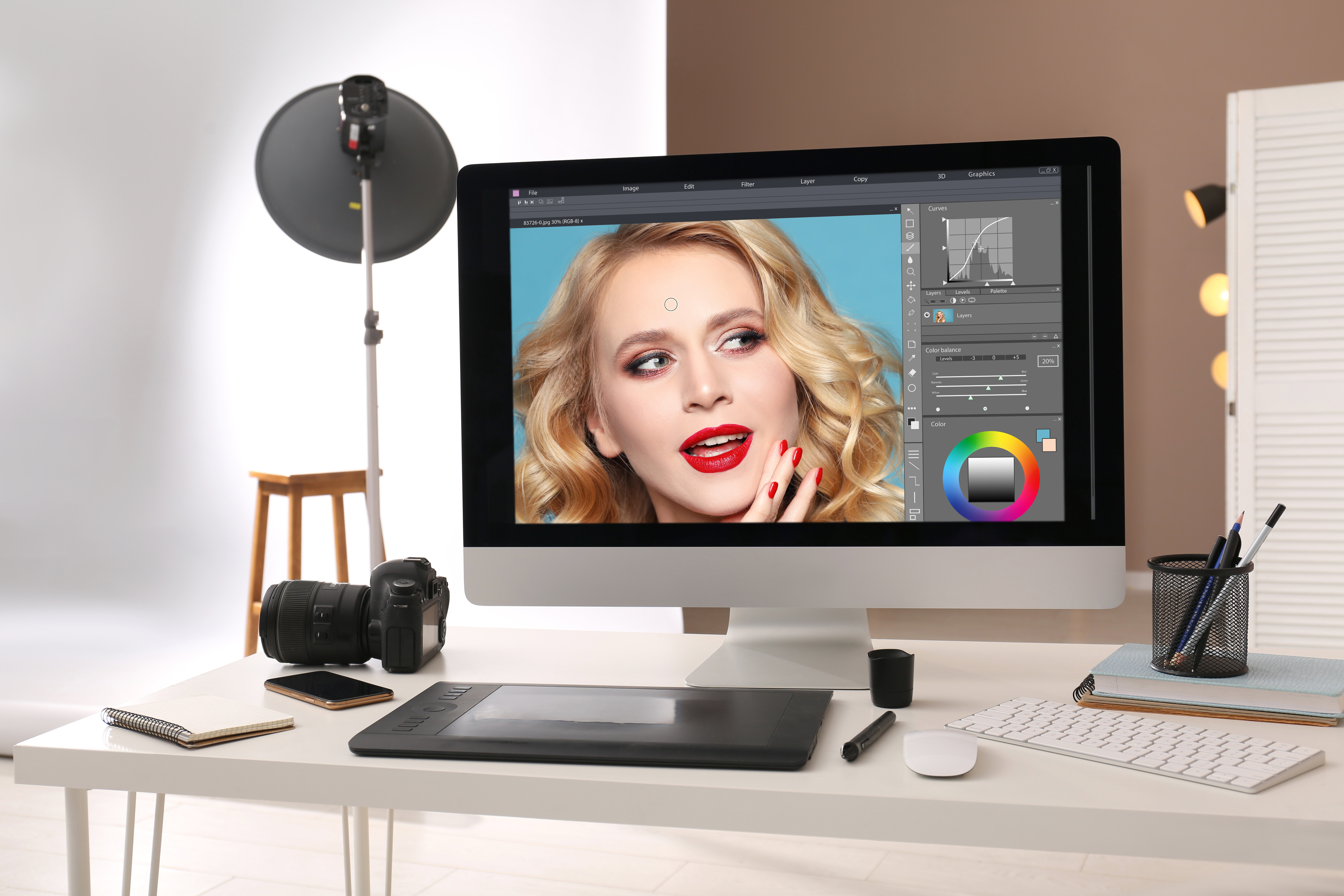 Retoucher workstation with photo editor, graphic tablet and camera for ecommerce image editing
